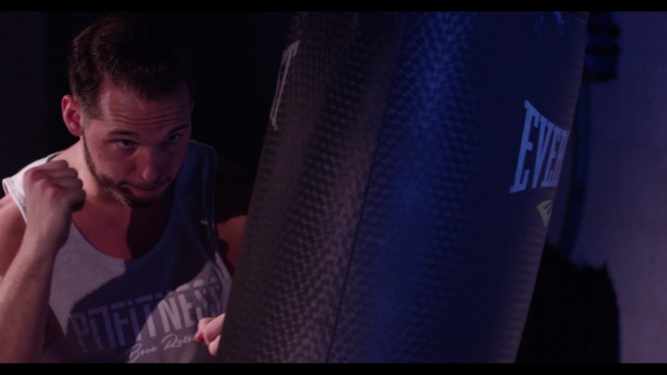 Man hitting punching bag without gloves 5 ClipStock