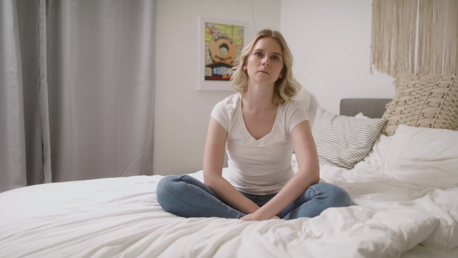 Beautiful blonde woman sitting looking empty blank