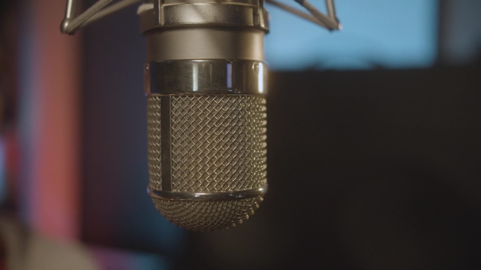 Detailed condenser microphone hanging upside down in recording studio