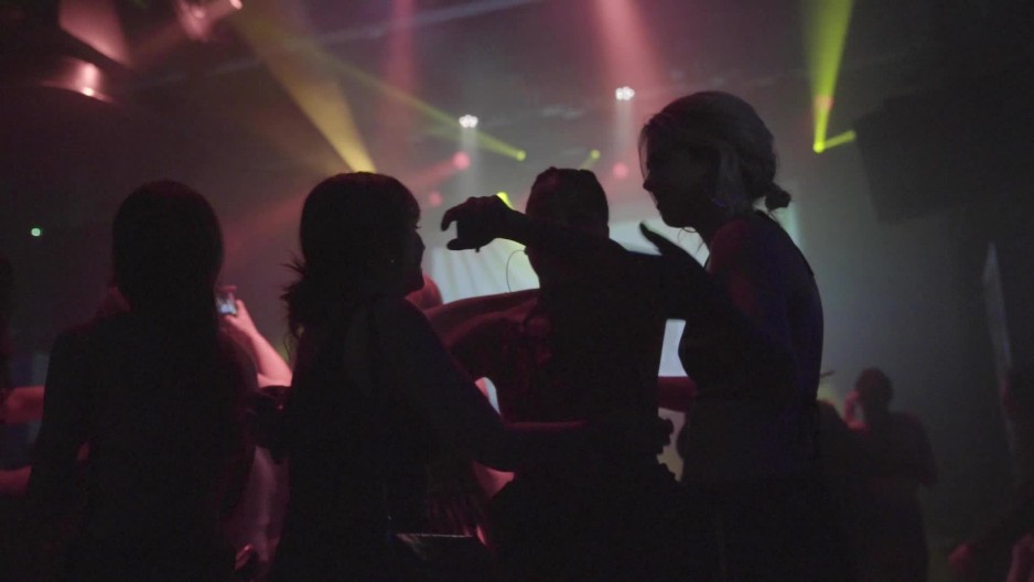 silhouette girl swaying her hips back and forth dancing in club at