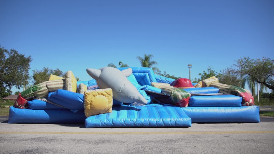 Static shot of bounce house being deflated time lapse ClipStock