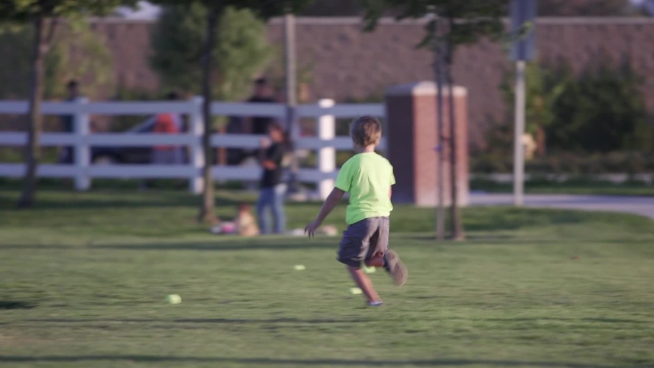 Young Boy Running To Pick Up Baseballs From The Ground Clipstock