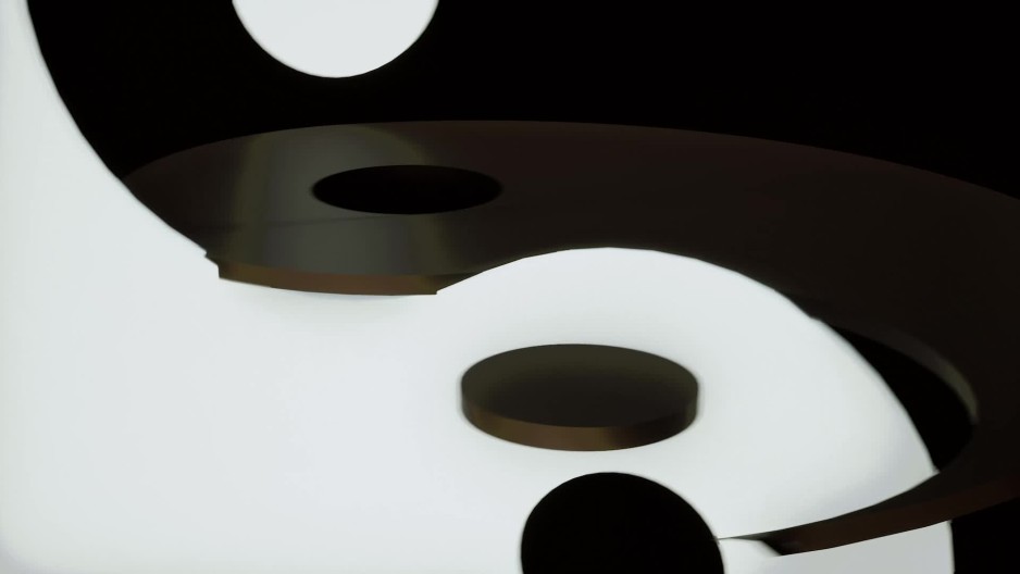 Tight shot of abstract yin and yang symbol spinning behind black