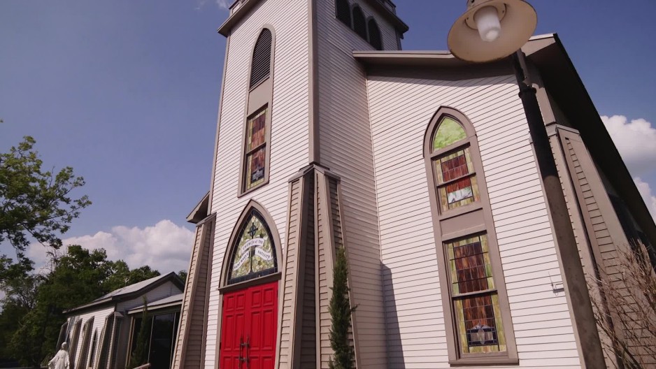 Tilt down of front of St Marys Catholic Church in Plantersville, TX