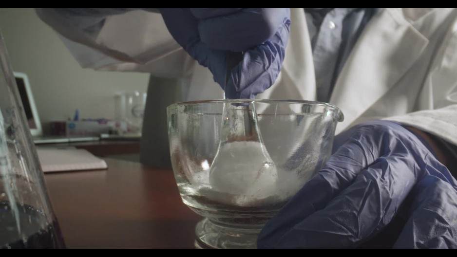 Chemist using mortar and pestle to crush and mix dry chemical compound in laboratory ClipStock