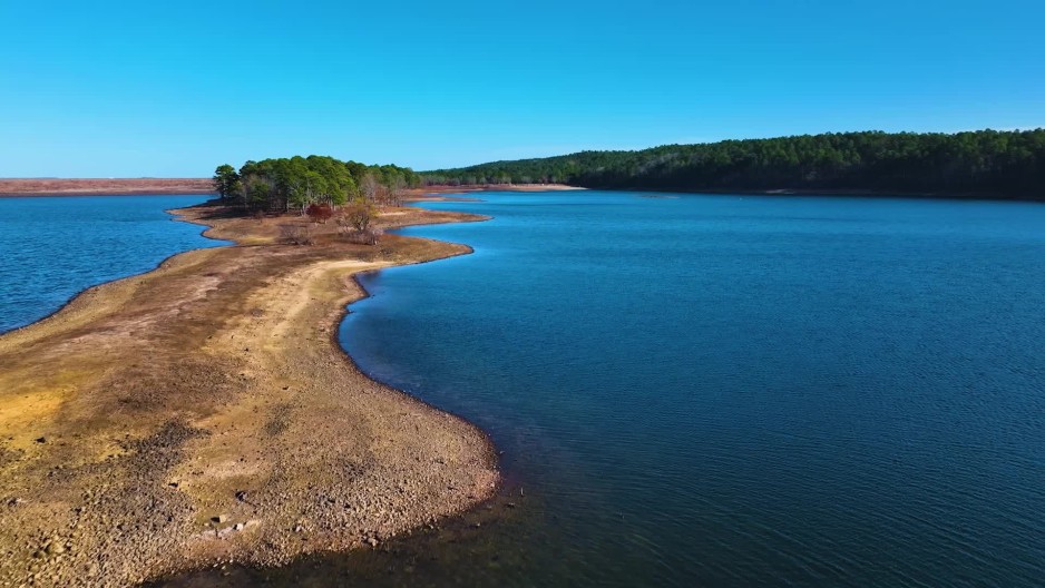 Strip of land with trees on DeGray Lake during day ClipStock
