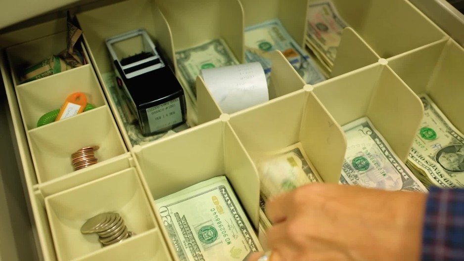 Close up of teller opening cash drawer ClipStock