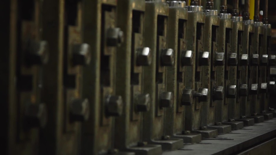 Spinning nuts and bolts on industrial machine ClipStock