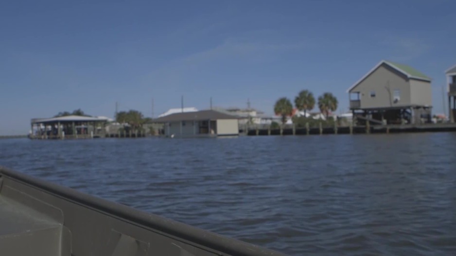medium rack focus from the side of a trolling boat of camps along
