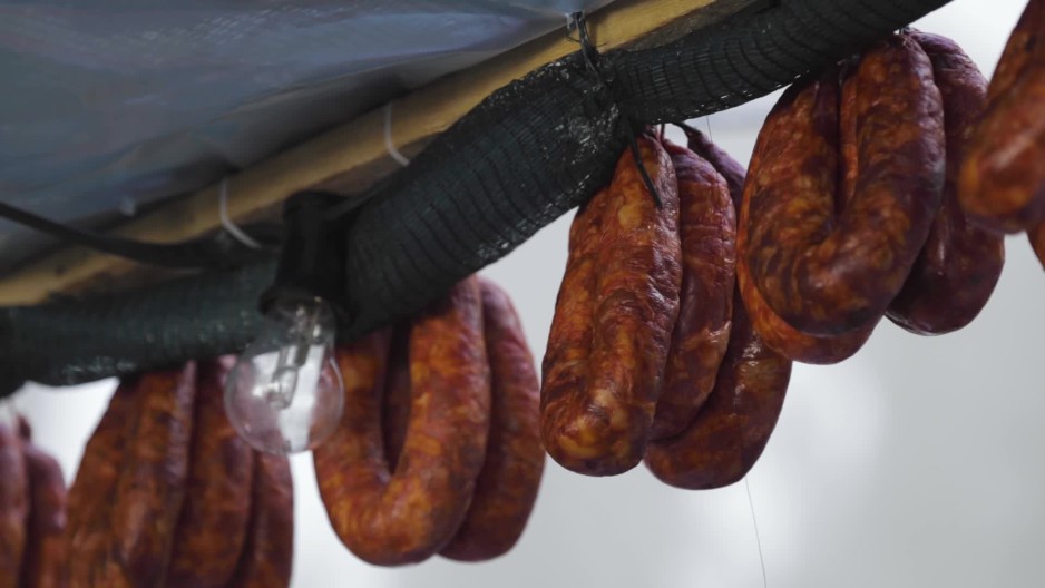 Smoked Sausage hanging outdoors at an event Slow Motion ClipStock