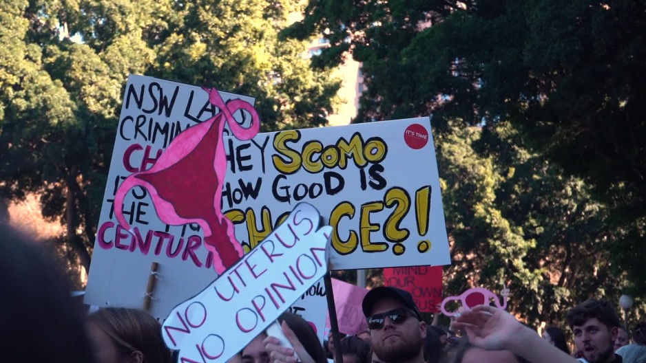 Pro choice activists holding waving pro choice signs at rally | ClipStock