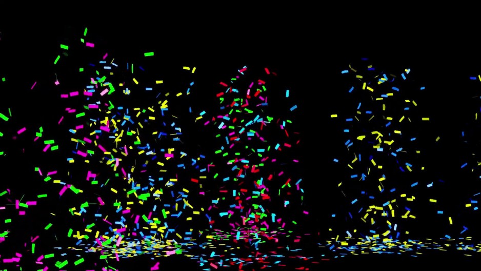 Animated bursts pop of confetti on black background ClipStock
