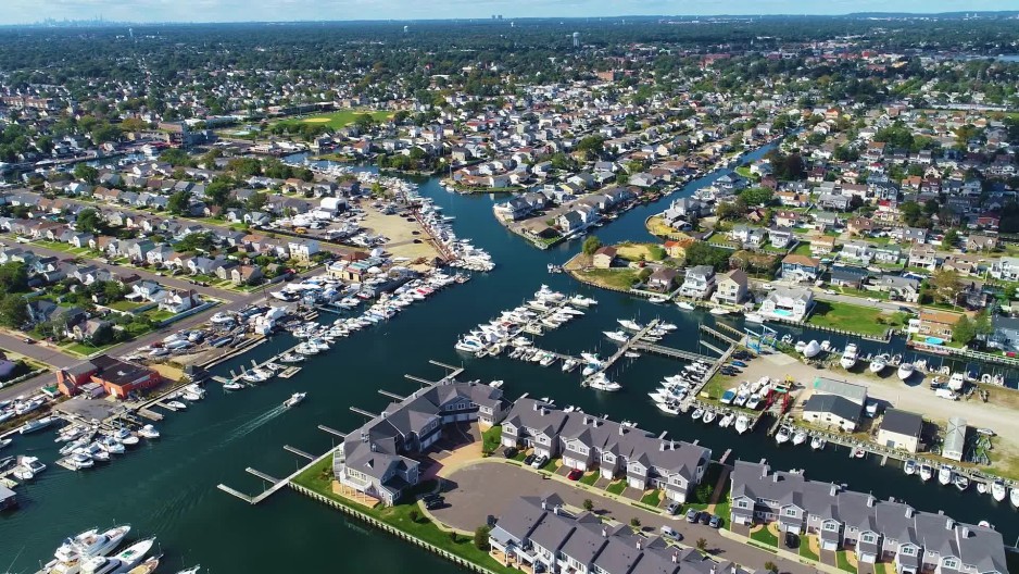 Luxurious waterfront village homes and boats docked at Freeport Bay