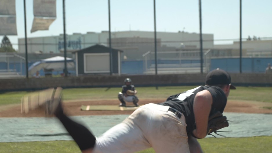pitcher on high school baseball team throws fastball to catcher during