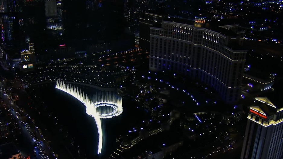 Las Vegas cityscape at night closing in on The Fountains of Bellagio