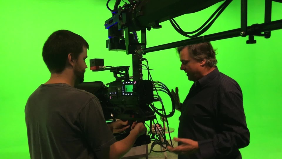 Professional male camera operator recording male talent with