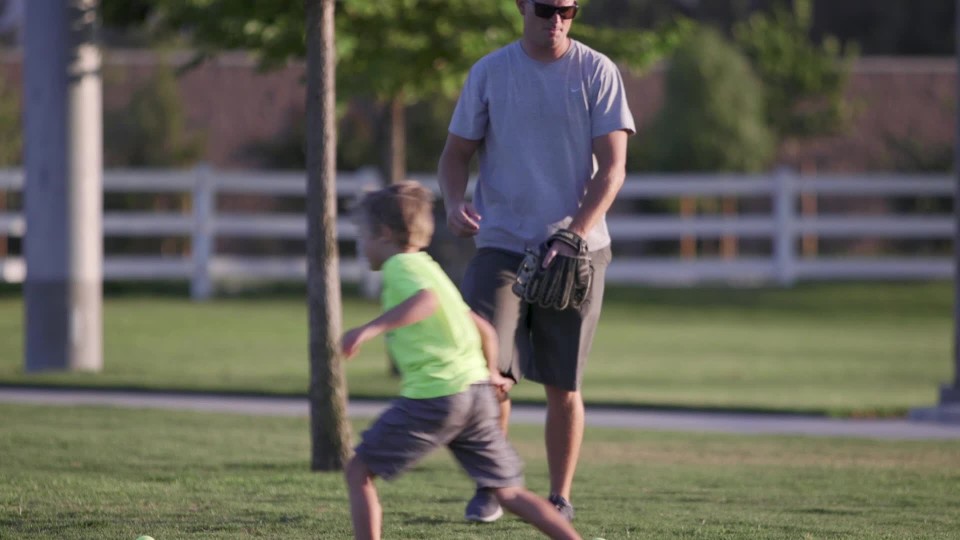 Young Boy Running To Pick Up Baseballs From The Ground Clipstock