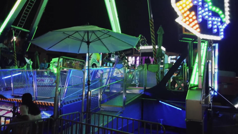 Riding Spinning Scrambler Amusement Park Ride At Night Slow Motion Clipstock