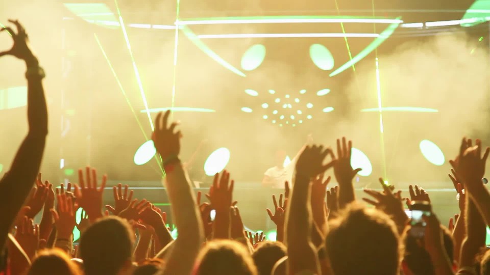 big concert stage at indoor venue with flashing lights ClipStock