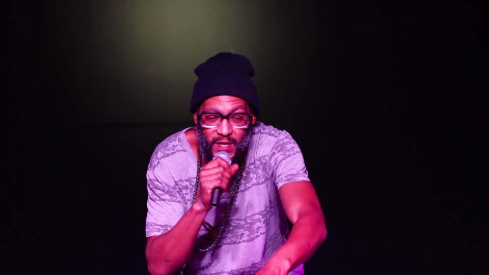 African American rapper listening to audience while performing song on