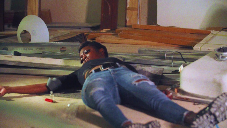 Young Black female high on heroin passed out on floor ClipStock