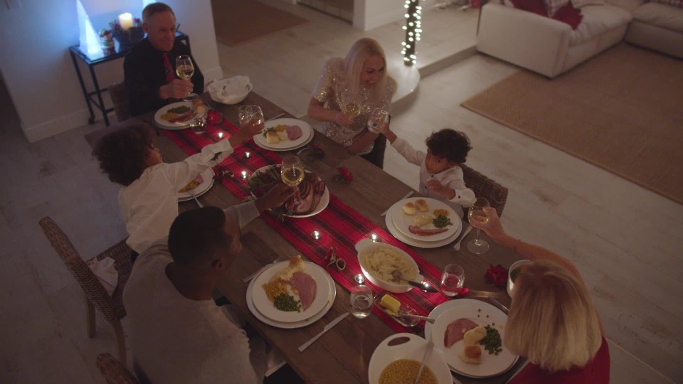 Hispanic multigenerational family toasting over Thanksgiving family