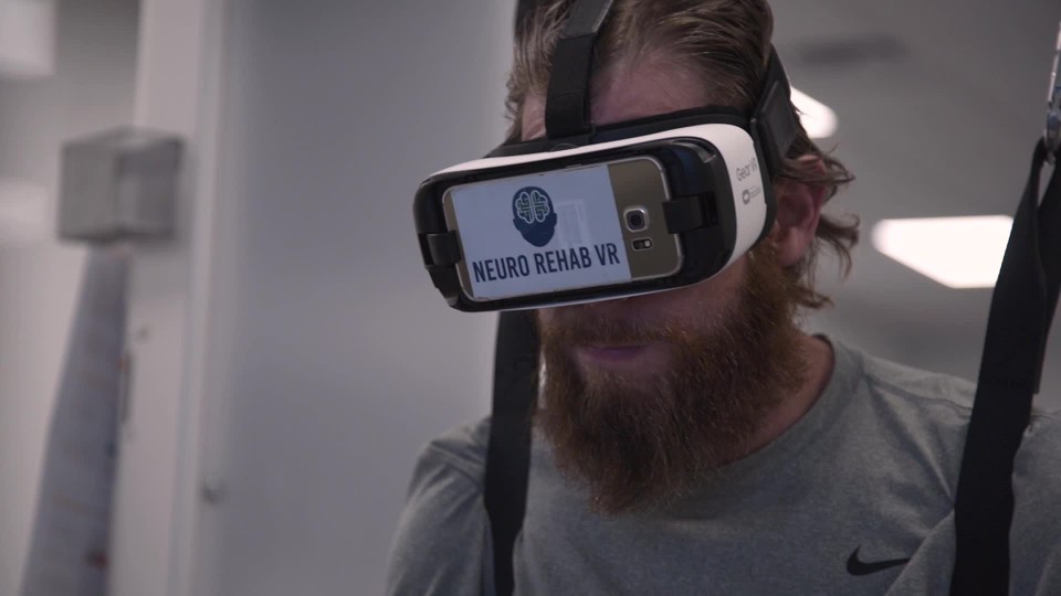 Legs of paraplegic patient walking on machine assisted unweighting