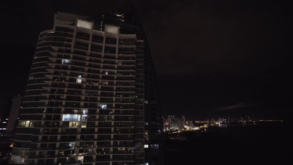 View From Hotel Balcony Looking Up At High Rise Building And Panama City Skyline Along Coast At Night Clipstock